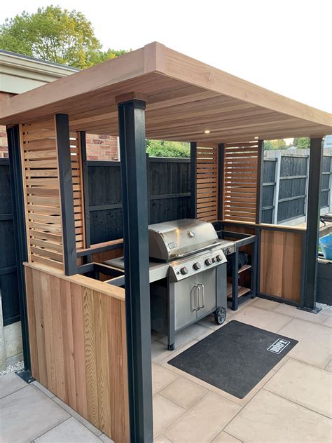 Outdoor grill shelter ideas - Using an L-shape configuration set within a custom designed permanent timber gazebo, this outdoor kitchen is cleverly zoned to include all of the key spaces required in an indoor kitchen for food prep, grilling and clearing away. On the right-hand side of the kitchen is the cooking run featuring the mighty 107cm Wolf outdoor gas grill.